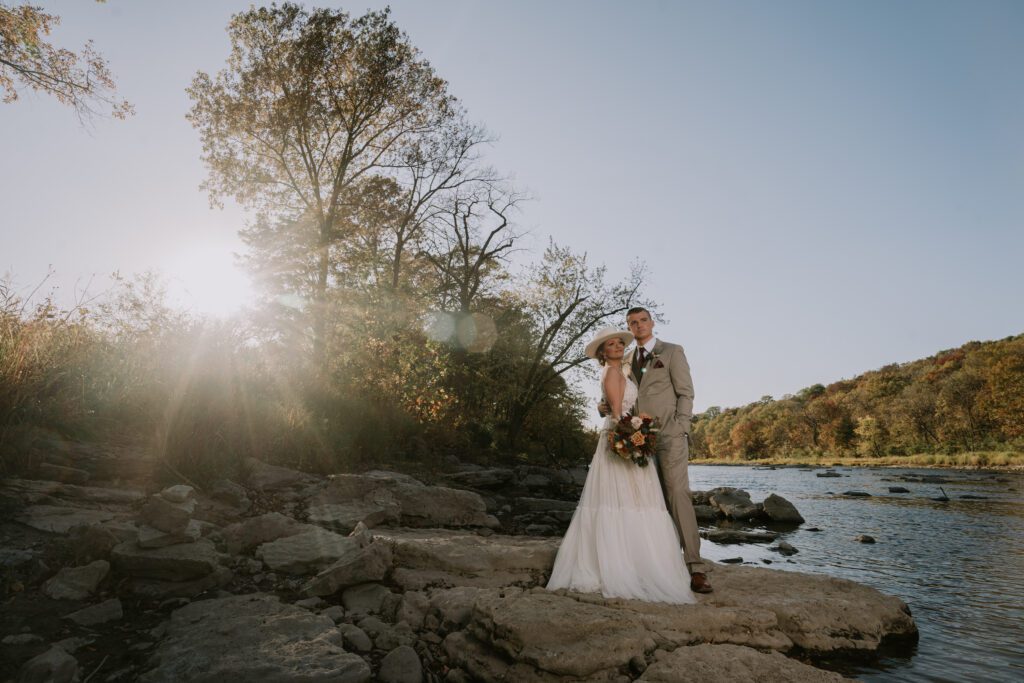 luxury campground wedding at Camp Aramoni | Bride and Groom at River